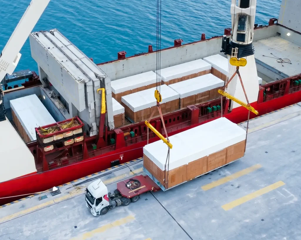heavy haul load at shipping dock getting loaded onto vessel.